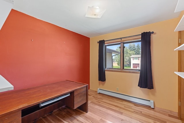 office area with baseboard heating and light wood-type flooring