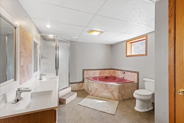 full bathroom featuring tile patterned floors, a drop ceiling, vanity, shower with separate bathtub, and toilet