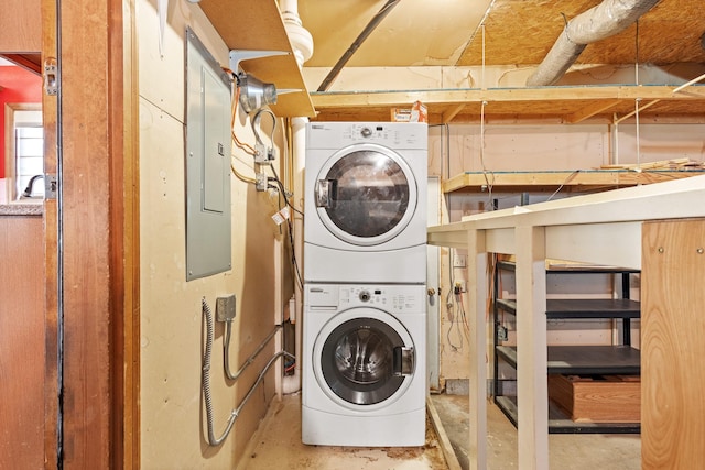 washroom with stacked washing maching and dryer, sink, and electric panel