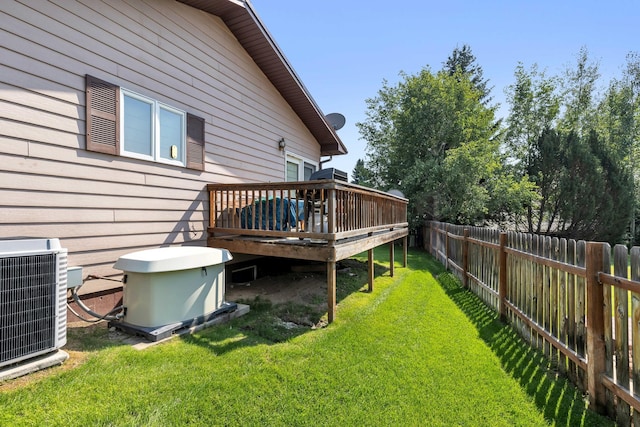 view of yard with central AC unit and a deck