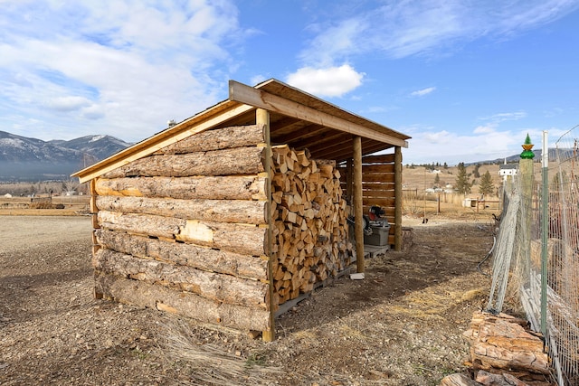 view of outdoor structure featuring a mountain view and a rural view