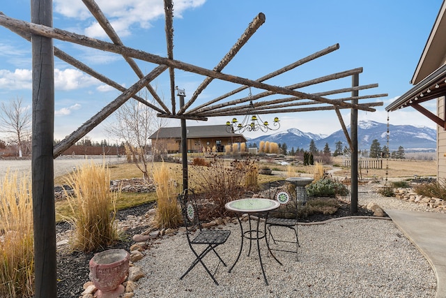 view of patio / terrace featuring a mountain view and a rural view