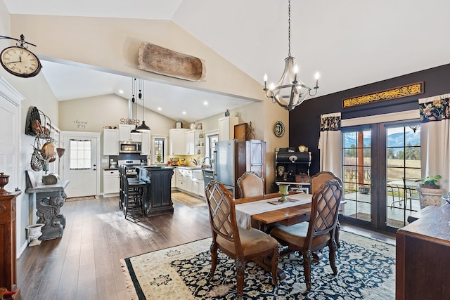 dining area featuring a chandelier, lofted ceiling, dark wood-type flooring, and french doors