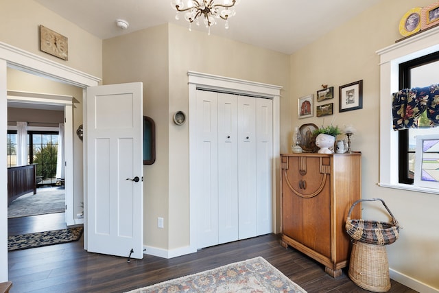 entrance foyer featuring dark hardwood / wood-style flooring and an inviting chandelier