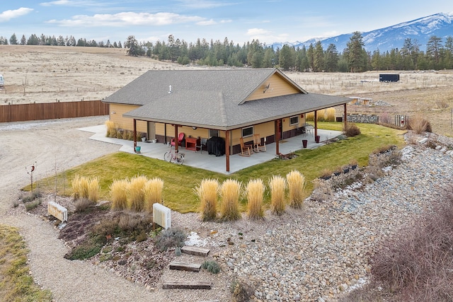 back of house featuring a mountain view and a patio