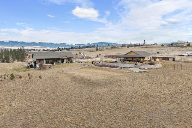 drone / aerial view featuring a mountain view and a rural view