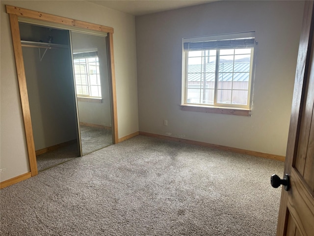 unfurnished bedroom featuring carpet and a closet