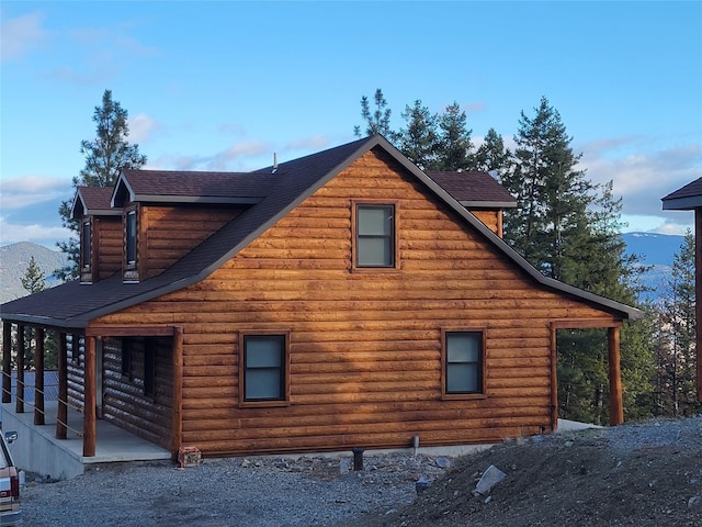 view of side of property with a mountain view