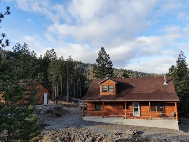 log-style house with a porch