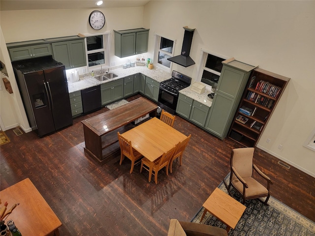 kitchen with black appliances, ventilation hood, green cabinets, sink, and dark hardwood / wood-style floors