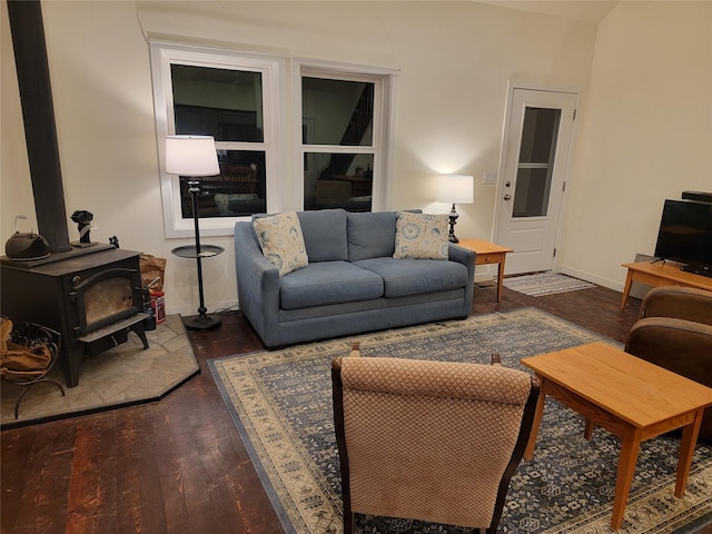 living room featuring dark hardwood / wood-style floors and a wood stove