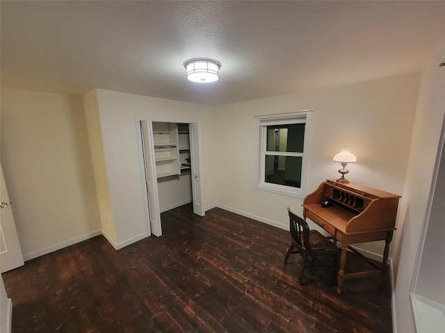 office area with dark hardwood / wood-style flooring and a textured ceiling