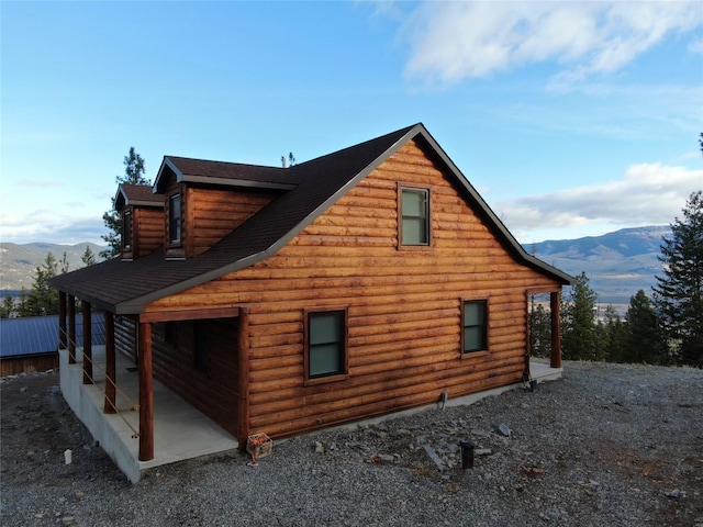 view of side of home featuring a mountain view