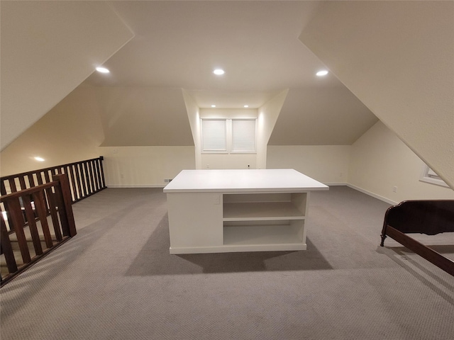 additional living space featuring carpet and vaulted ceiling