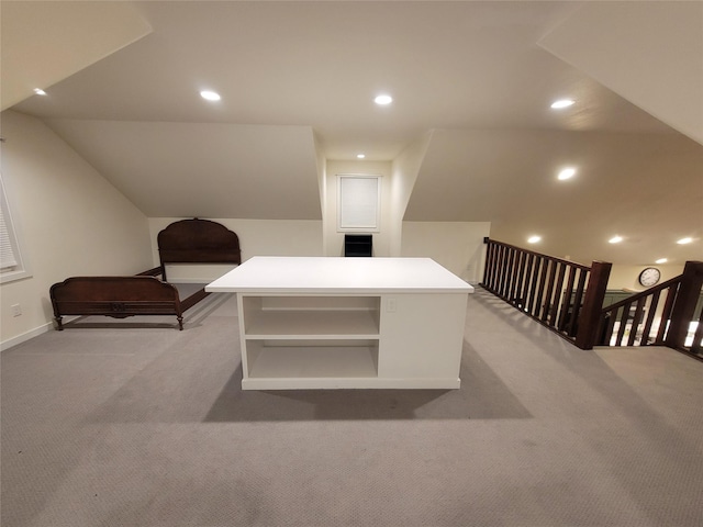 carpeted office featuring lofted ceiling