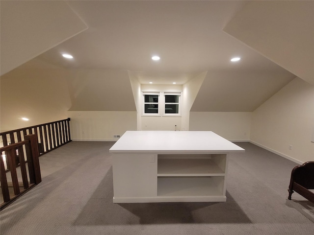 additional living space featuring carpet floors and lofted ceiling