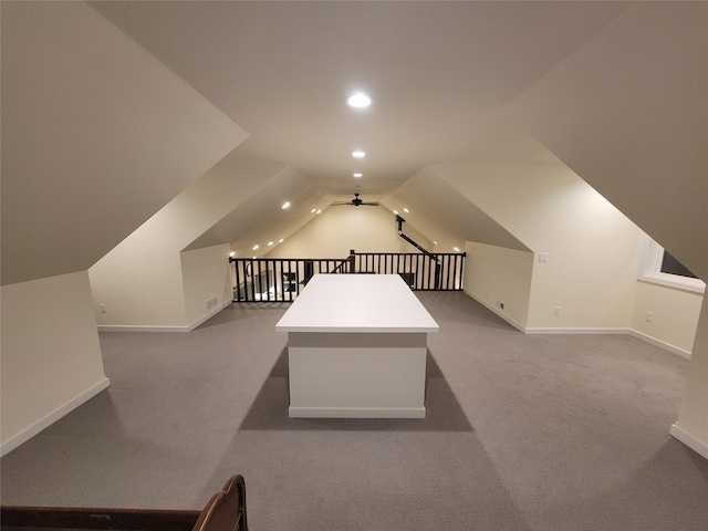 additional living space featuring carpet flooring, vaulted ceiling, and ceiling fan