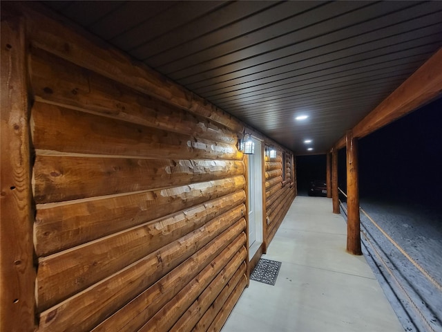 hallway featuring rustic walls