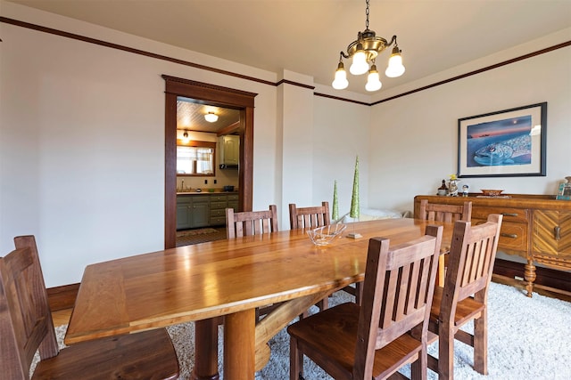 dining space featuring an inviting chandelier and sink