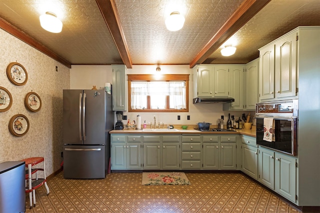 kitchen featuring beamed ceiling, sink, crown molding, and black appliances