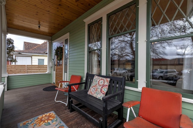 wooden terrace featuring covered porch