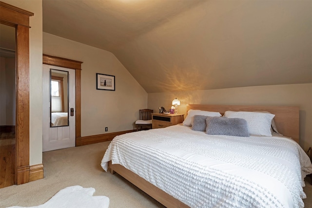 carpeted bedroom featuring lofted ceiling