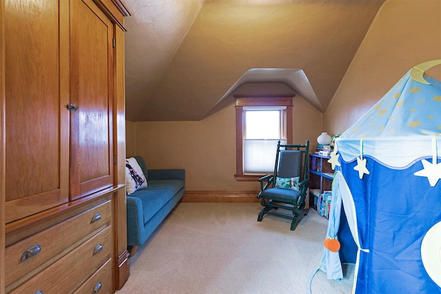 sitting room with light colored carpet and vaulted ceiling