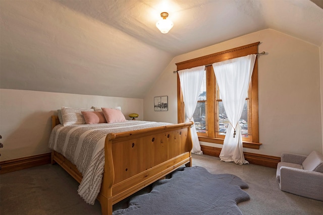 carpeted bedroom with vaulted ceiling and multiple windows