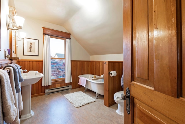 bathroom with a baseboard radiator, vaulted ceiling, and a bathing tub