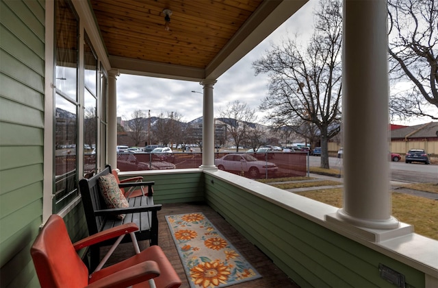 balcony featuring a mountain view and covered porch