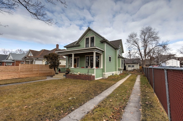 view of front of property with covered porch and a front yard