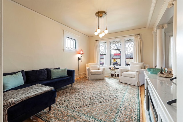 living room featuring crown molding and an inviting chandelier