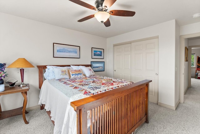 carpeted bedroom with a closet and ceiling fan