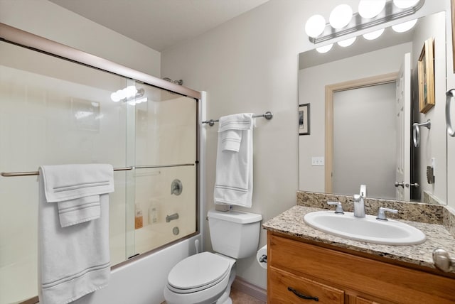 full bathroom featuring toilet, combined bath / shower with glass door, and vanity