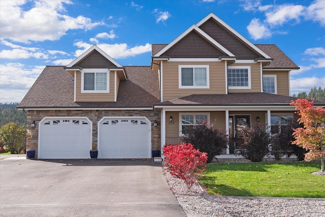 view of front of property featuring a front yard and a garage