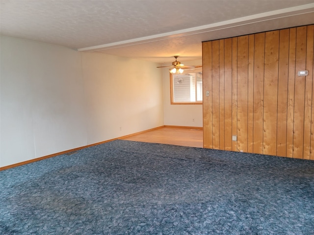 unfurnished room with a textured ceiling, carpet floors, and ceiling fan