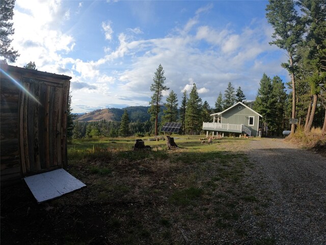 rear view of property featuring a wooden deck