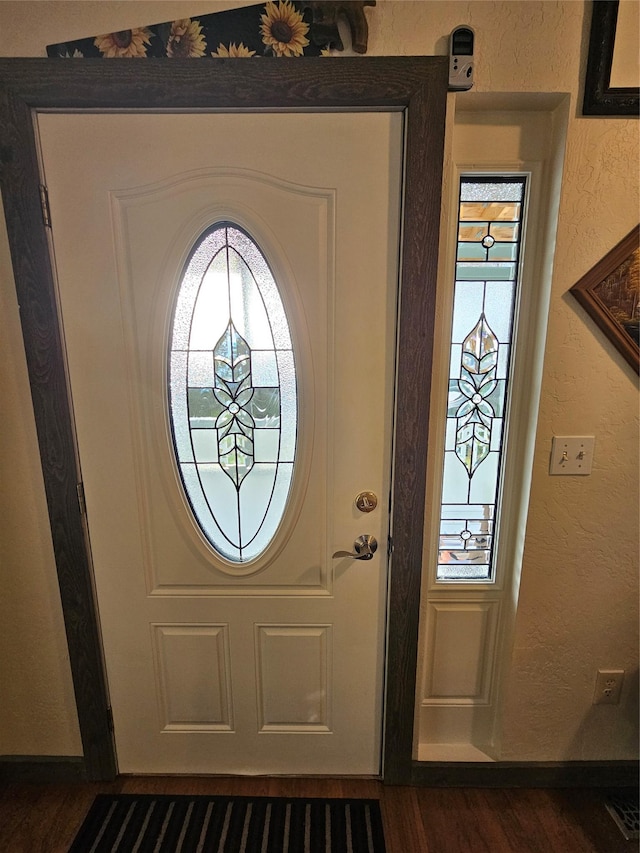 entryway with dark wood-type flooring