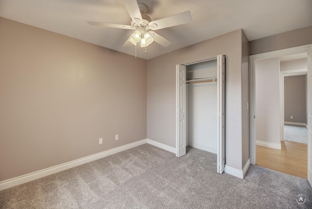 unfurnished bedroom featuring ceiling fan, light colored carpet, and a closet