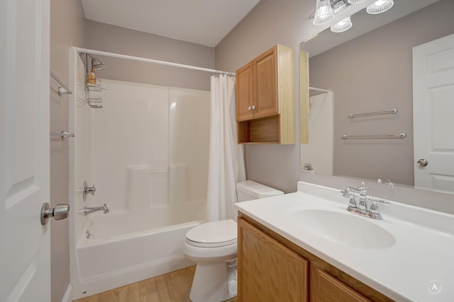 full bathroom with toilet, hardwood / wood-style floors, vanity, and shower / bath combo with shower curtain