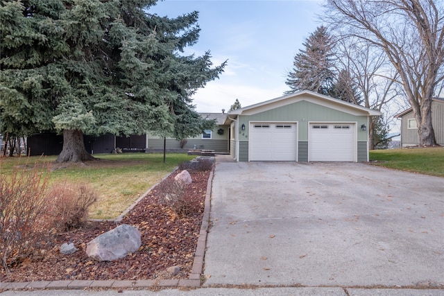 view of front of property with a front yard and a garage