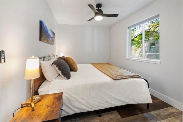 bedroom with ceiling fan, baseboards, and wood finished floors