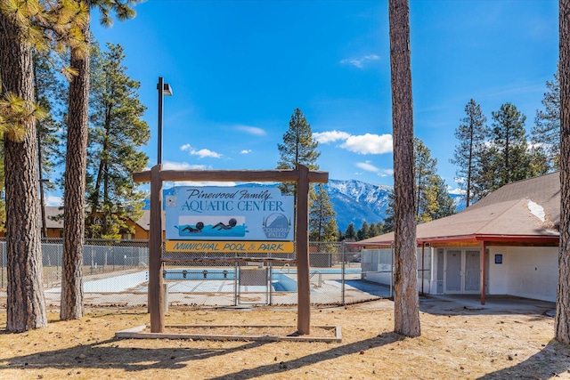 exterior details featuring a mountain view and fence