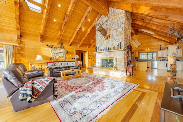 805 Georgetown Lake Rd, Anaconda, MT 59711 - living room featuring wooden walls, hardwood / wood-style flooring, high vaulted ceiling, wooden ceiling with exposed beams, and a fireplace