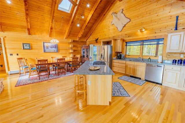 805 Georgetown Lake Rd, Anaconda, MT 59711 - kitchen with stainless steel appliances, wooden ceiling with exposed beams, wooden walls, light wood-style flooring, and high vaulted ceiling