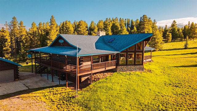 805 Georgetown Lake Rd, Anaconda, MT 59711 - back of property featuring a lawn, log exterior, a chimney, and driveway