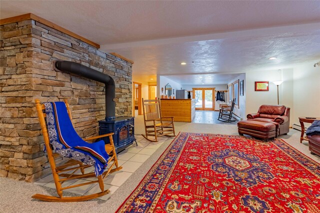 805 Georgetown Lake Rd, Anaconda, MT 59711 - living area featuring a wood stove, baseboard heating, tile patterned flooring, and a textured ceiling