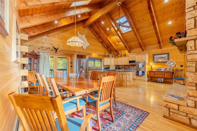 805 Georgetown Lake Rd, Anaconda, MT 59711 - dining area with a skylight, wood ceiling with exposed beams, light wood finished floors, high vaulted ceiling, and wooden walls