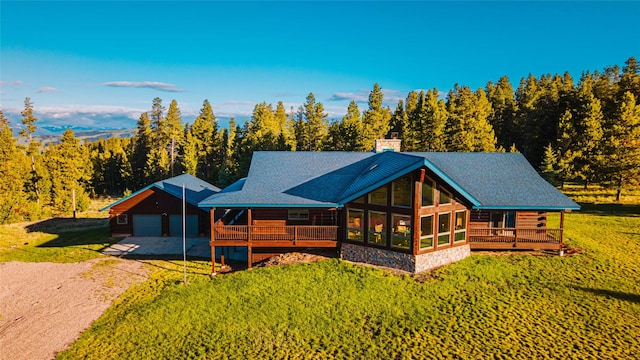 805 Georgetown Lake Rd, Anaconda, MT 59711 - view of front of property with a garage, a front yard, a chimney, dirt driveway, and a wooded view