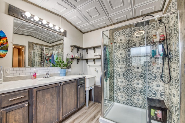 bathroom with decorative backsplash, a shower with door, wood-type flooring, and vanity